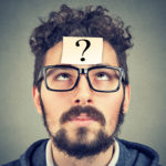 Man with question mark attached to his forehead