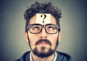 Man with question mark attached to his forehead